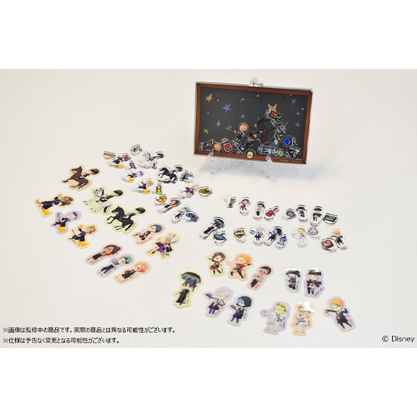 Acrylic frame displayed behind numerous small acrylic character stand pieces arranged on a white surface.