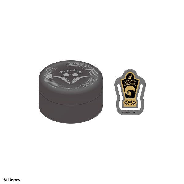 A round dark tin with a white decorative emblem shown beside a coffin-shaped clip featuring a "Happy Halloween" design.