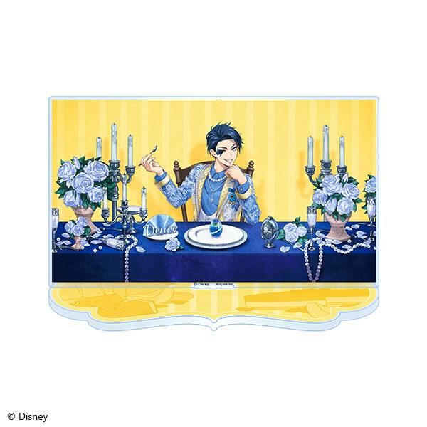 Acrylic stand of Deuce Spade showing the character seated at a decorated table against a yellow background.