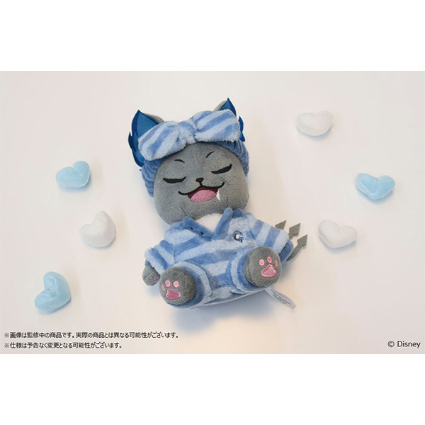 Photograph of the Grim sitting plush (くつろぎ・マイルーム ver.) wearing blue striped pajamas and a matching headband, lying among small heart-shaped cushions.