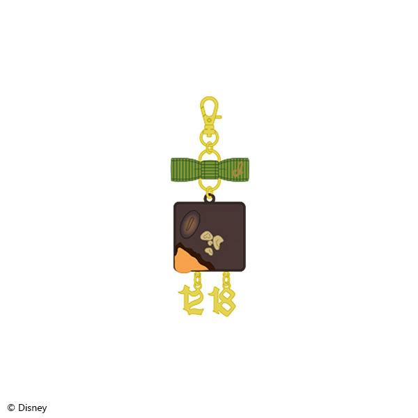 Front view of the La・ボンボニエール ver. brooch charm for Idia Shroud: square chocolate-themed charm with a green bow, gold number dangles, and a gold lobster clasp.