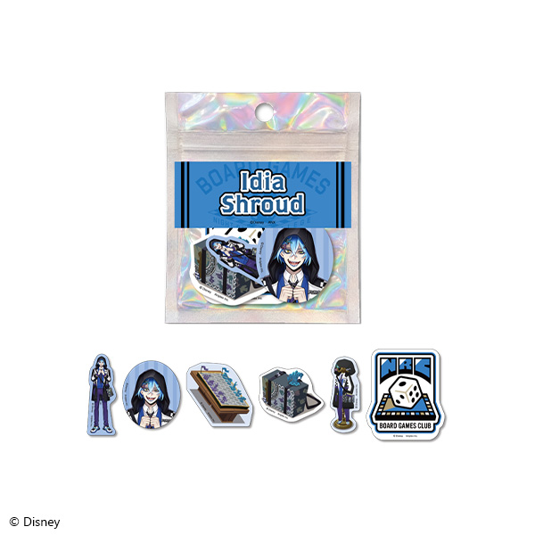 Photo of a sealed holographic pouch labeled "Idia Shroud" with a set of paper stickers featuring Idia Shroud and themed club icons displayed below.