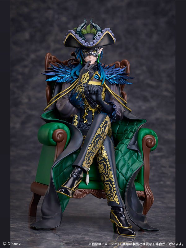 Figure of Malleus Draconia from Disney Twisted Wonderland seated on a green armchair wearing a decorative mask, hat, and a black-and-gold outfit.