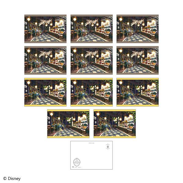 Photo of the postcard set showing multiple identical illustrated postcards of a café interior arranged in a grid with a sample blank postcard back at the bottom.