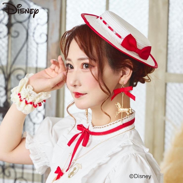 A woman modeling the ladies' mini hat (white with red trim and bow) worn on her head.