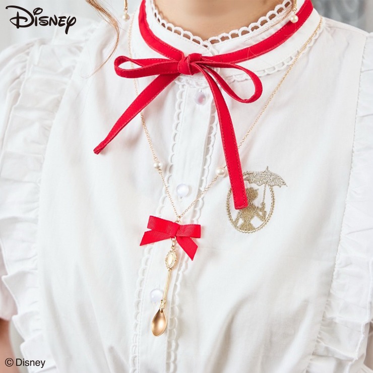 Model wearing the listed women's Disney necklace with a red ribbon bow and a dangling pendant.
