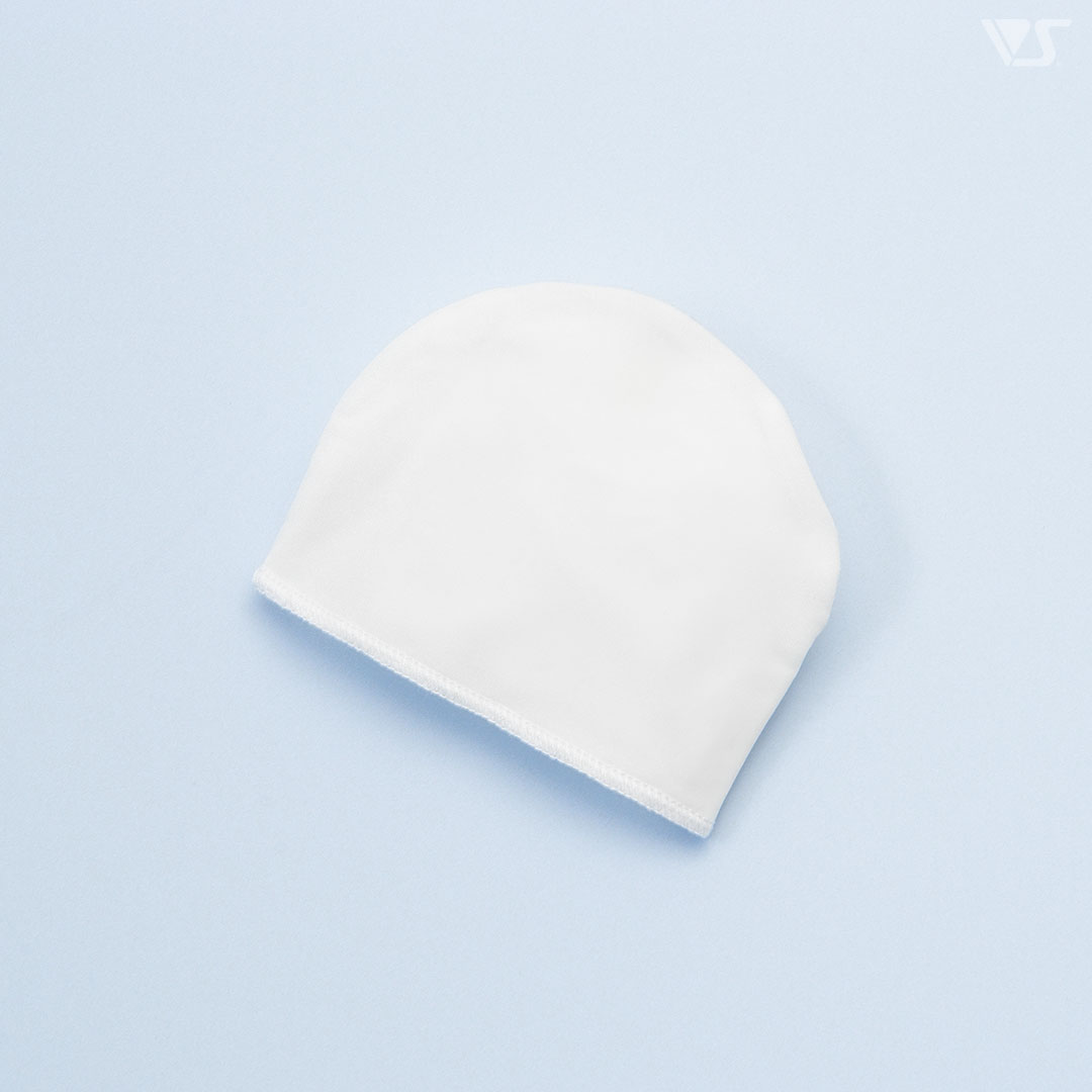 White doll head cap laid flat on a light blue background.