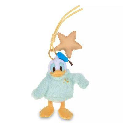 Donald Duck plush keychain wearing a light blue sweater with a star-shaped charm and yellow strap.