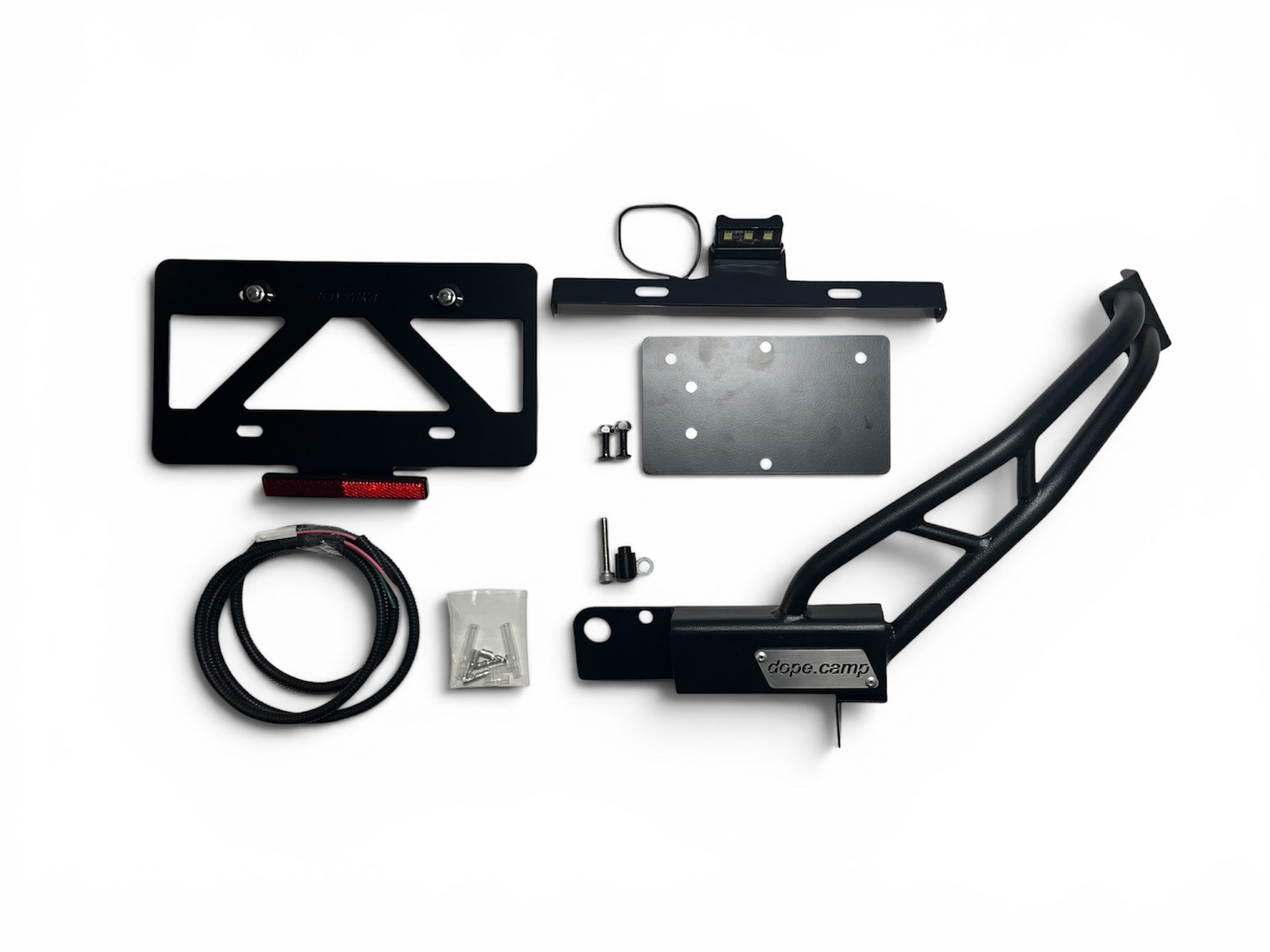 Black metal center number holder/frame guard and its mounting hardware arranged on a white background.