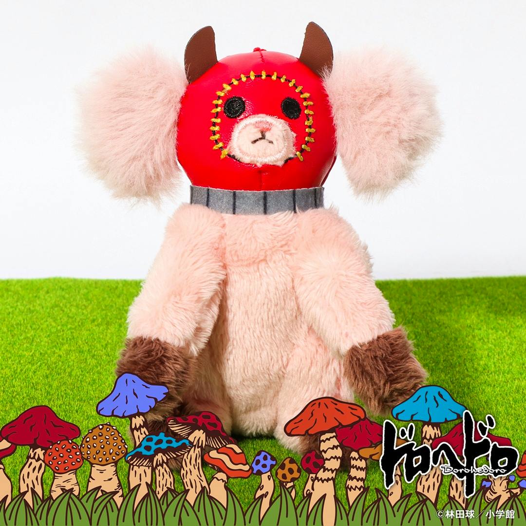 Kikurage mascot plush keychain from Dorohedoro pictured sitting on a green surface wearing a red hooded mask, with illustrated mushrooms and the series logo at the bottom.