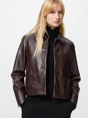 Model wearing a brown synthetic leather men's short coat with a collar, front buttons, and patch pockets.