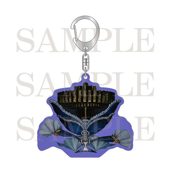 An acrylic charm keychain with a purple background and a blue decorative motif attached to a metal clasp keyring.