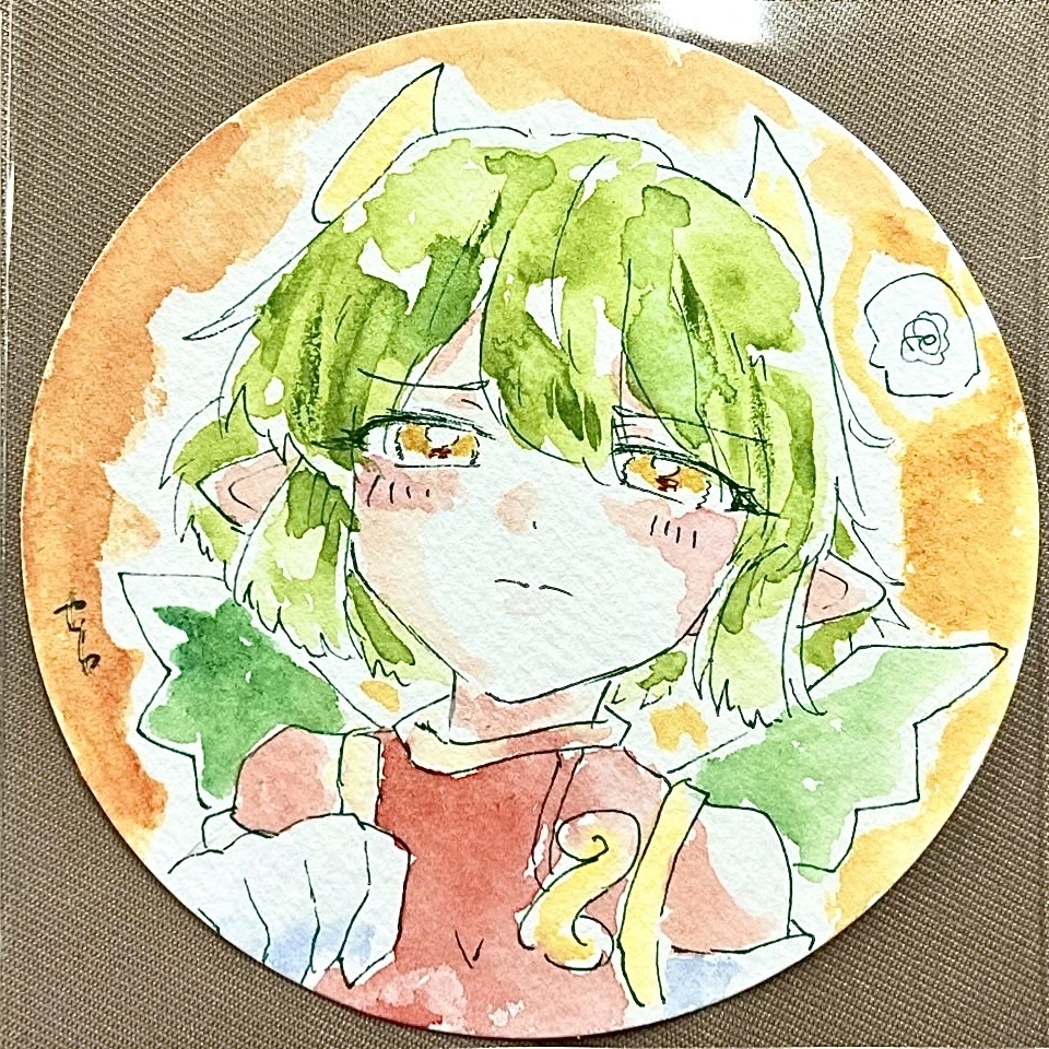 Round watercolor illustration of a green-haired, horned character with small wings on paper.