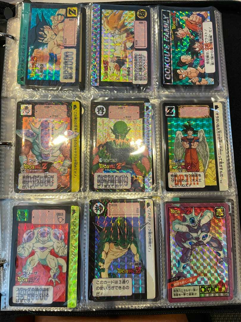 A binder page showing nine holographic Dragon Ball trading cards in clear plastic pocket sleeves.