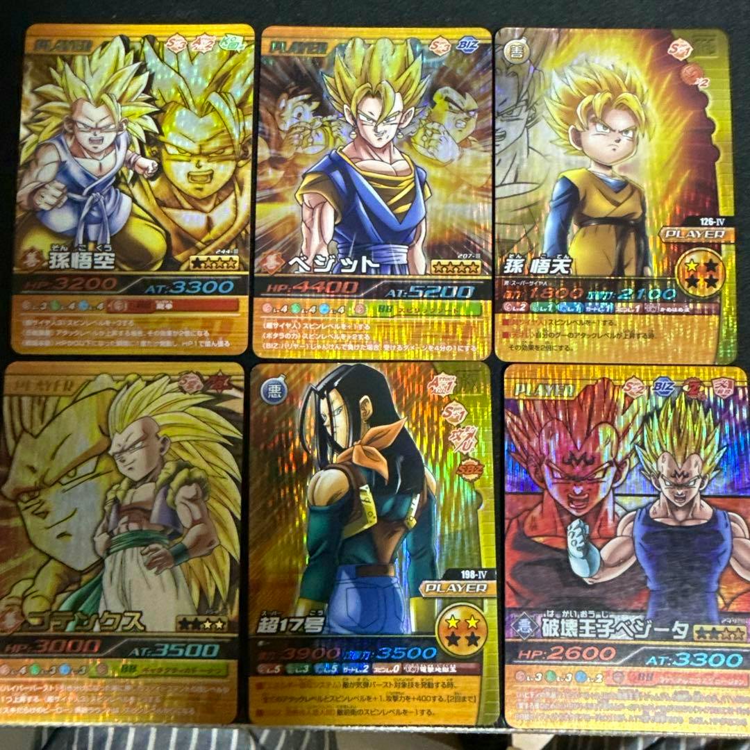 Photo of six Dragon Ball Data Carddass trading cards arranged in two rows of three on a dark surface, showing various characters.