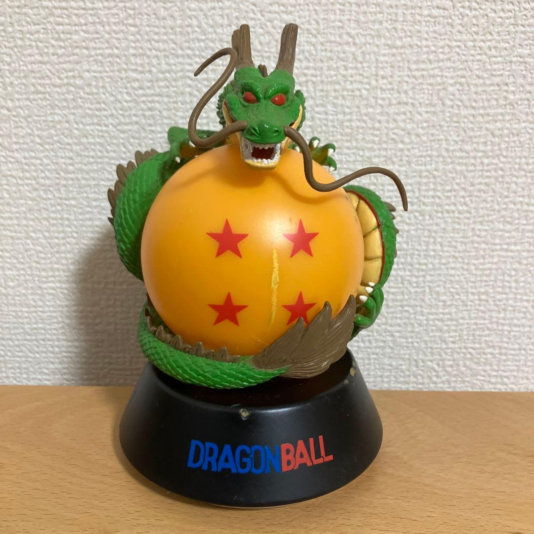 Front view of a Dragon Ball LED table lamp showing a green dragon coiled around an orange four-star Dragon Ball on a black base labeled DRAGONBALL.