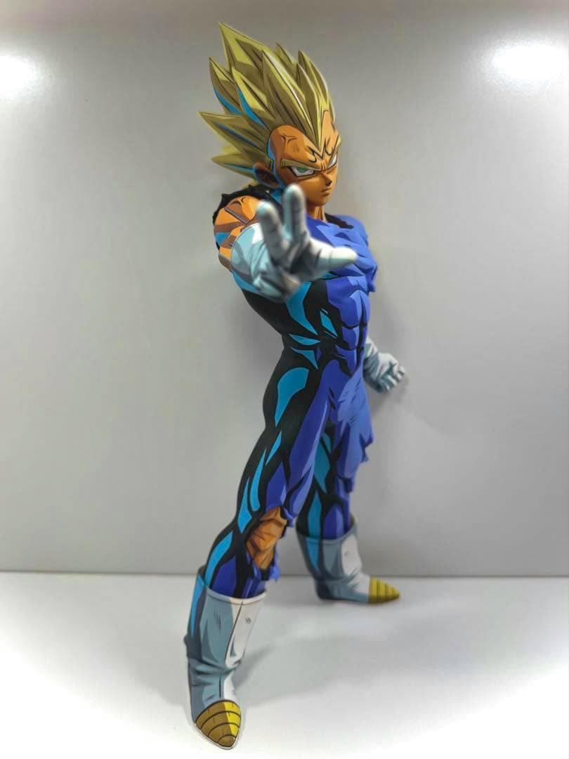 Repainted Majin Vegeta plastic figure in a blue torn battle suit standing with one arm extended against a plain light background.