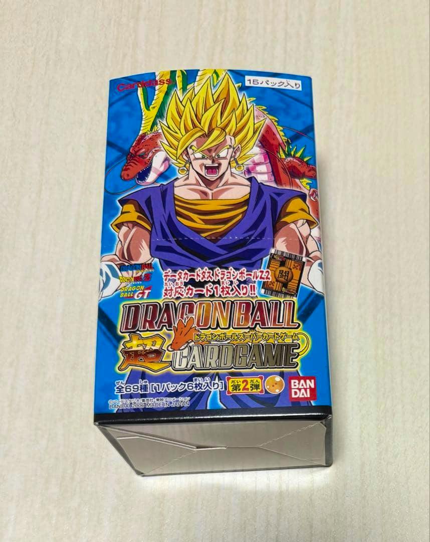Front view of an unopened Dragon Ball Super Card Game second-series box showing character artwork and the Bandai logo.