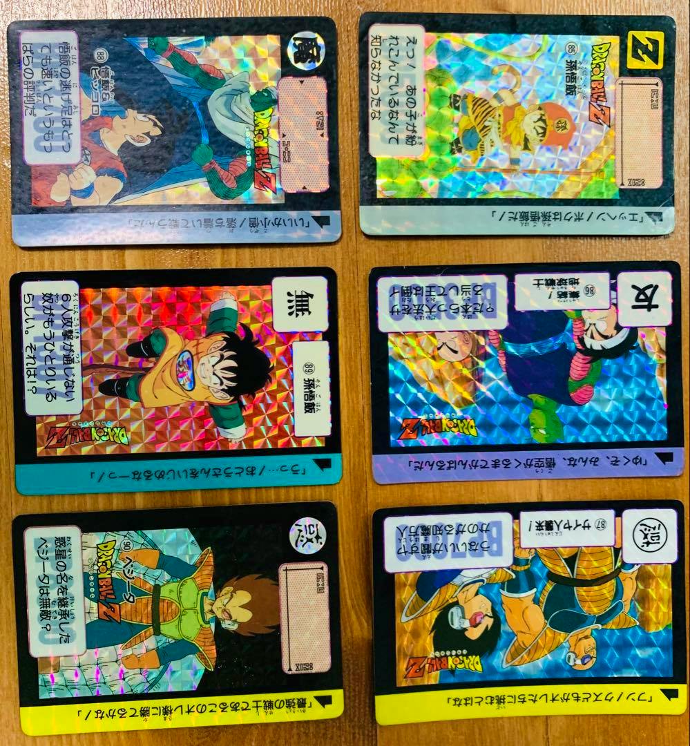 Six Dragon Ball Z holographic photocard fronts arranged in two columns on a wooden surface.