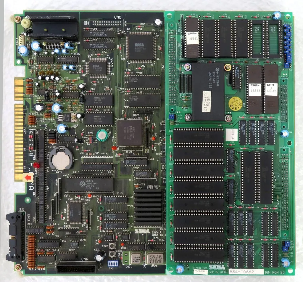 Top-down photo of the arcade PCB (Dragon Ball Z VRVS) with attached motherboard showing chips, sockets, and electronic components.