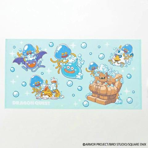 Light blue Dragon Quest bath towel showing various Slime characters and bubbles printed on it.