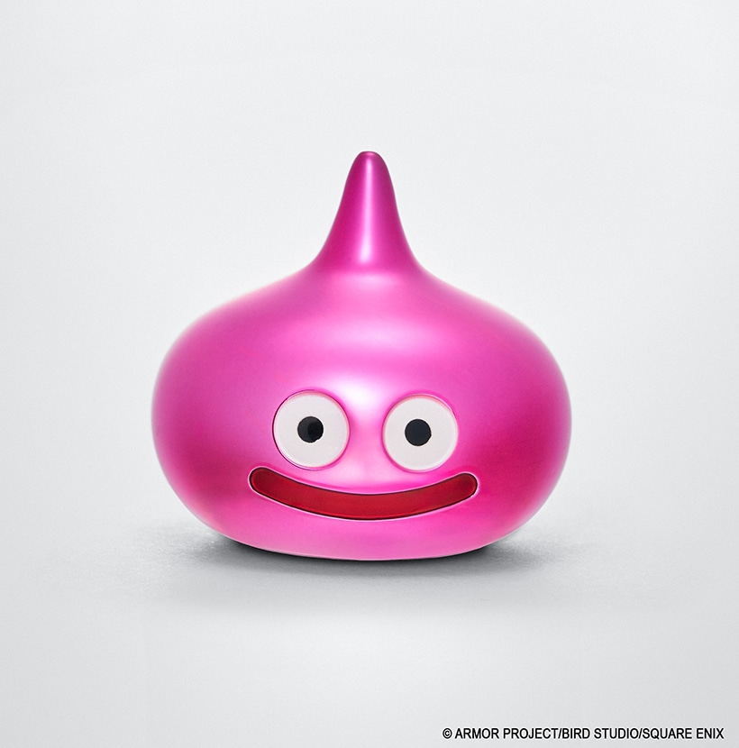 Front view of a metallic Dragon Quest Peach Slime figure showing round eyes and a smiling mouth.