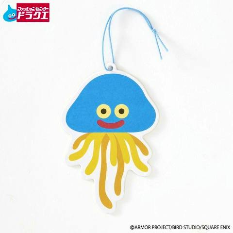 Paper room air freshener showing a blue Dragon Quest slime-like character with yellow tentacles and a blue hanging string.