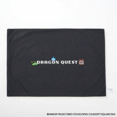 Black pillow cover showing a centered 'DRAGON QUEST' pixel-art logo with small sprite icons.