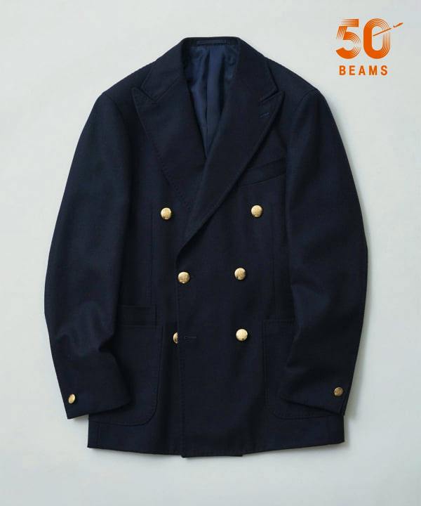 A navy wool flannel double-breasted men's blazer with gold buttons laid flat on a light background.