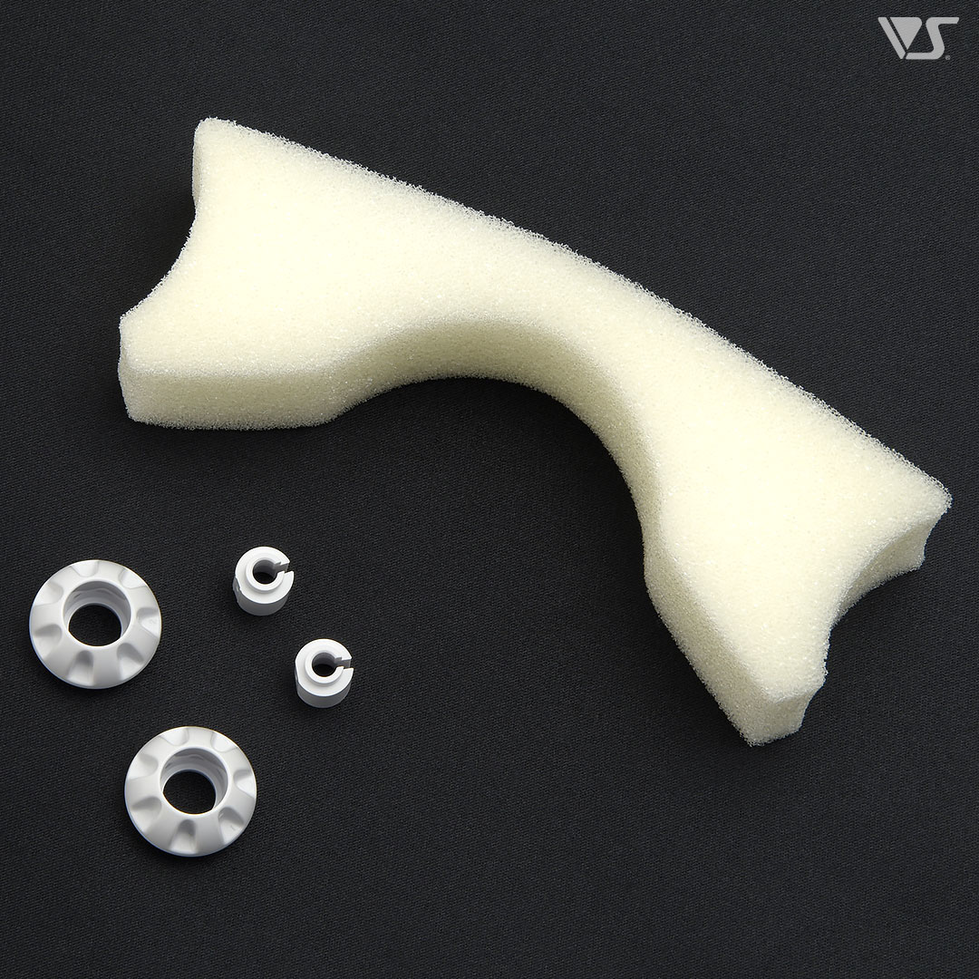 A white foam bath sponge piece with three small white plastic fittings on a dark background.