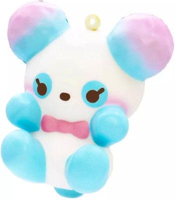 Front view of a small white plush toy character with blue-and-pink ears, blue paws and feet, a pink bow, and a small hanging loop at the top.