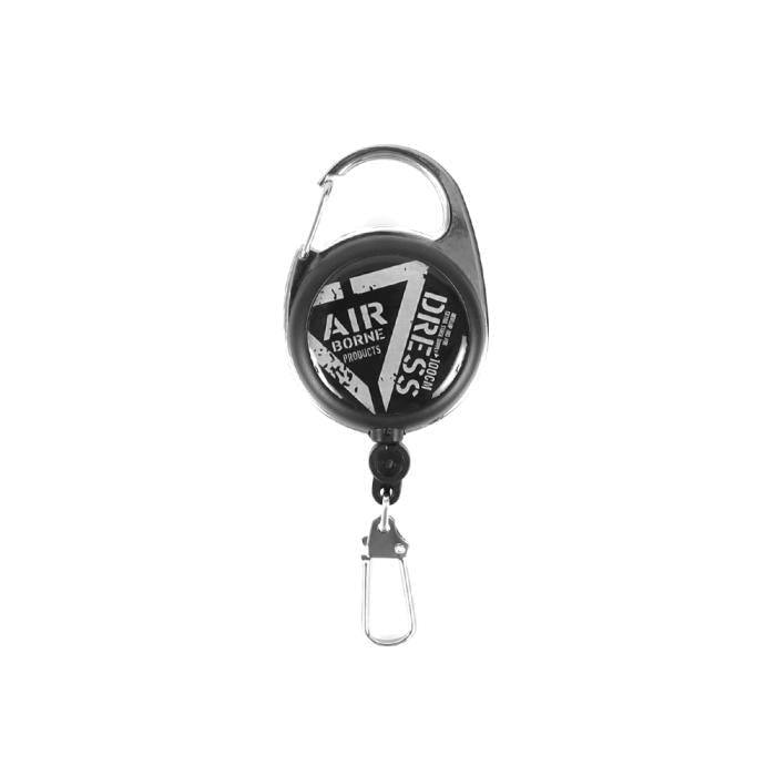 Photograph of the DRESS Major pin-on reel keychain with carabiner and clip on a white background.