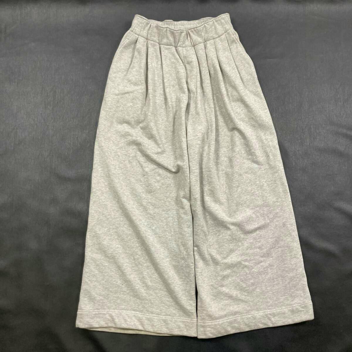 Flat lay of light heather gray wide women's sweatpants with pleats and an elastic waistband.