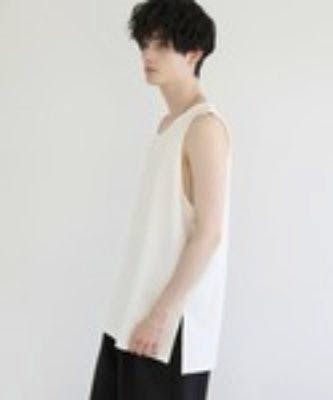 Side view of a model wearing a white long layered tank top.