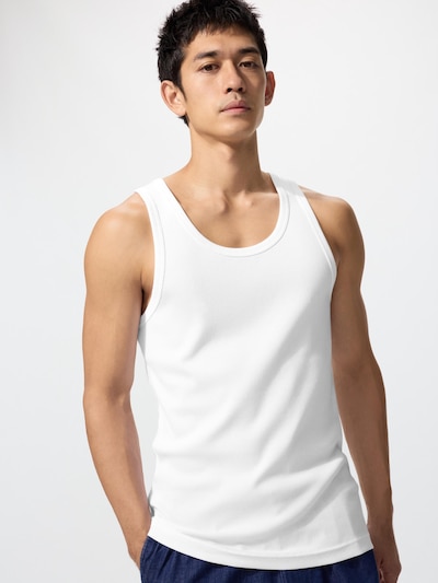 Male model wearing a white ribbed tank top shown from the front against a plain background.