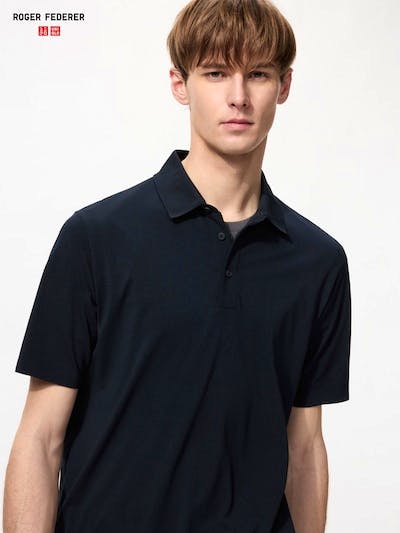 Male model wearing a dark short-sleeve men's polo shirt, shown from the chest up.