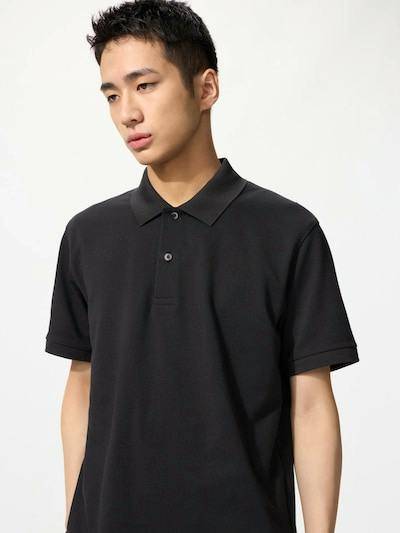 A male model shown from the torso up wearing a black dry kanoko polo shirt.