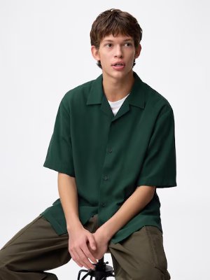 Male model wearing a men's polyester dry open-collar shirt in green.
