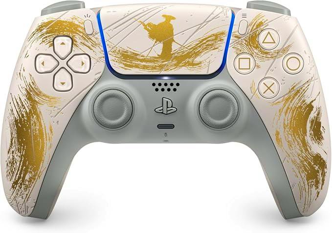 Front view of the DualSense wireless controller "Ghost of Yōtei" gold limited edition showing a white controller with gold brushstroke artwork and standard PlayStation buttons.
