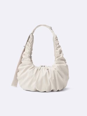 Front view of a light-colored dumpling-style polyester shoulder bag with ruched detailing.