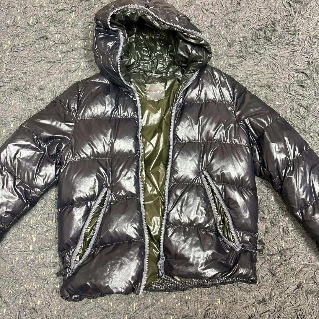 DUVETICA down jacket laid flat, showing the front with hood, center zipper, and zippered pockets.