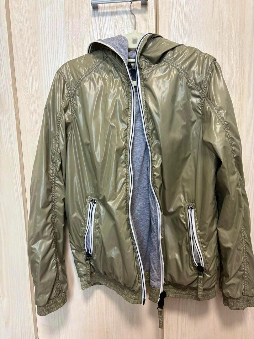 Front view of a DUVETICA olive-green nylon men's jacket (size 48) with hood hanging on a hanger.