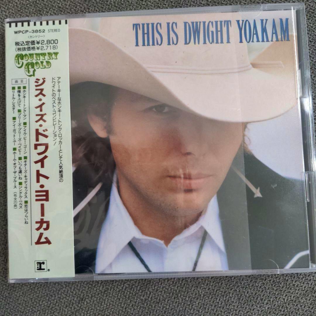 Front cover of the CD "This Is Dwight Yoakam" showing a close-up of a person wearing a cowboy hat and a vertical Japanese obi strip.