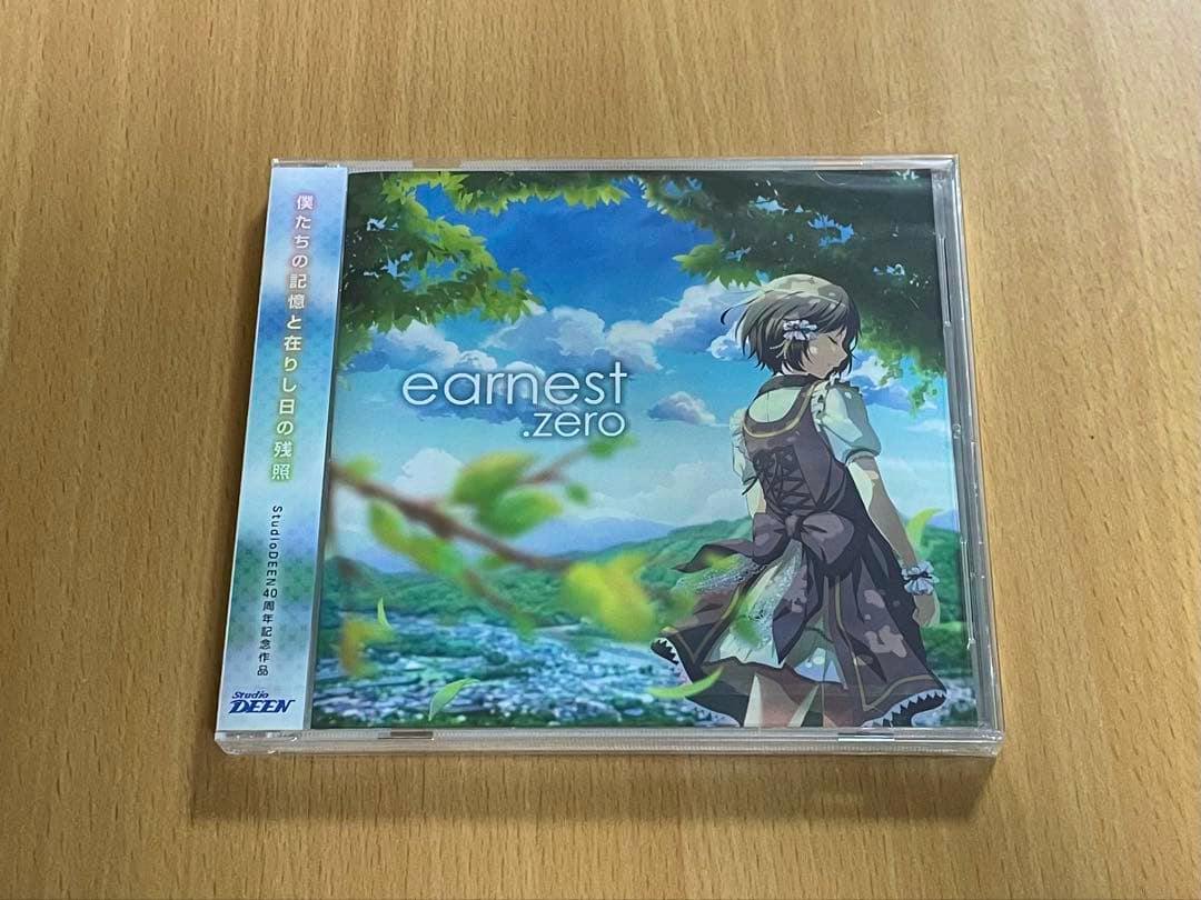 Front of the earnest.zero limited edition CD in its plastic case showing the illustrated cover art and obi strip on a wooden surface.