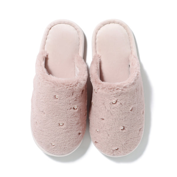 Top-down view of a pair of pink faux-fur room slippers decorated with small pearl-like beads on a white background.