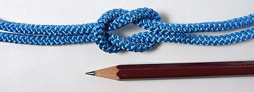 Close-up of a light-blue braided 5mm cord tied in a knot with a pencil shown for scale.