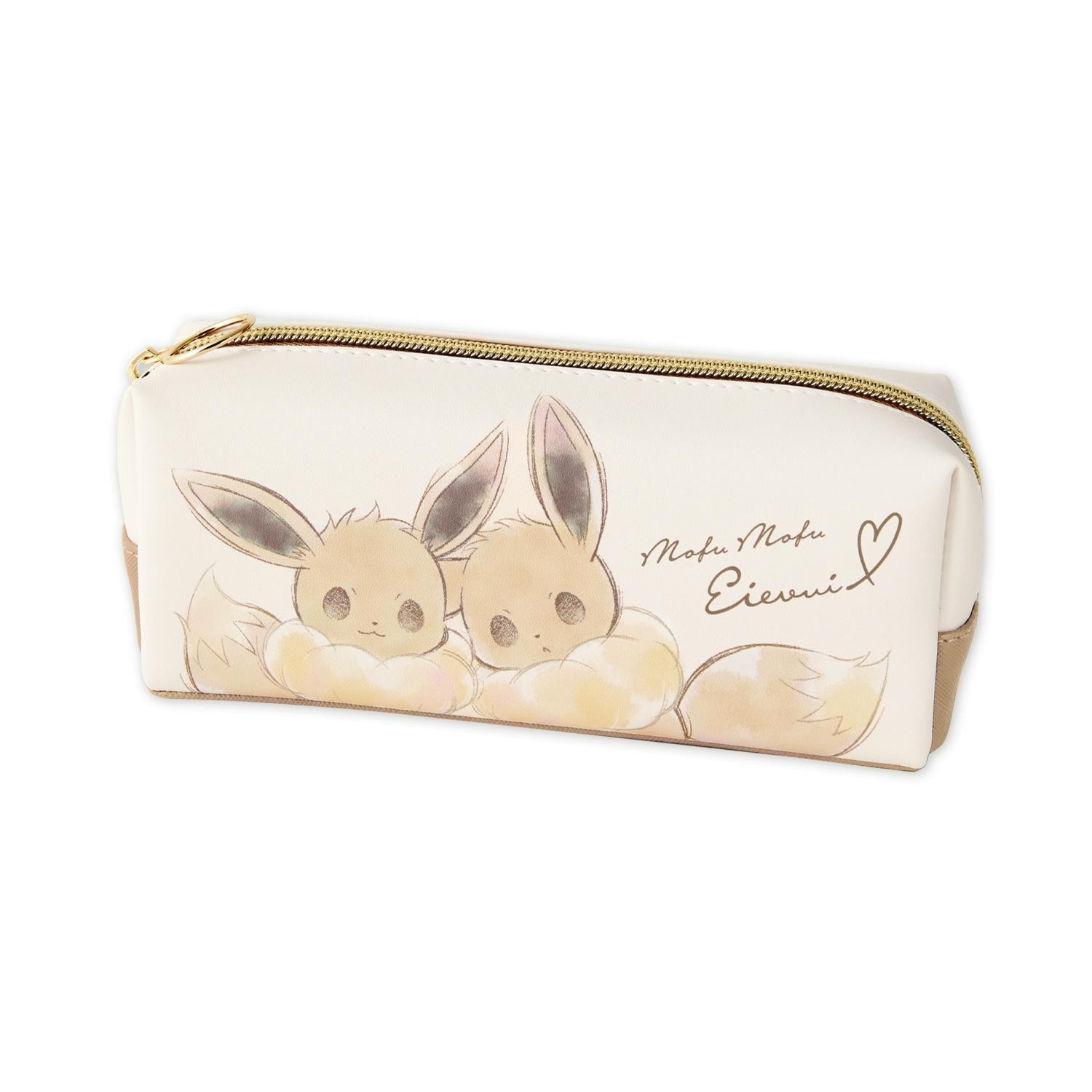 Cream-colored rectangular zippered multi-purpose case with two Eevee illustrations on the front and a gold zipper.