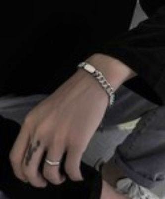 A silver plate chain bracelet shown worn on a model's wrist.