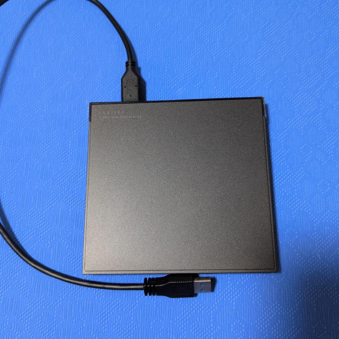 External slim Blu-ray optical drive LBD-PWA6U3VBK shown flat with its USB cable on a blue surface.