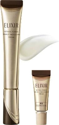 Gold tubes of Elixir Retino Power Wrinkle Reducing Cream, including a mini tube, shown with a smear of cream.